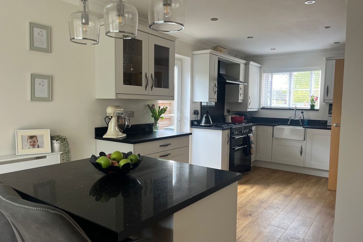 Shaker style kitchen cabinets wrapped in a clay matt finish