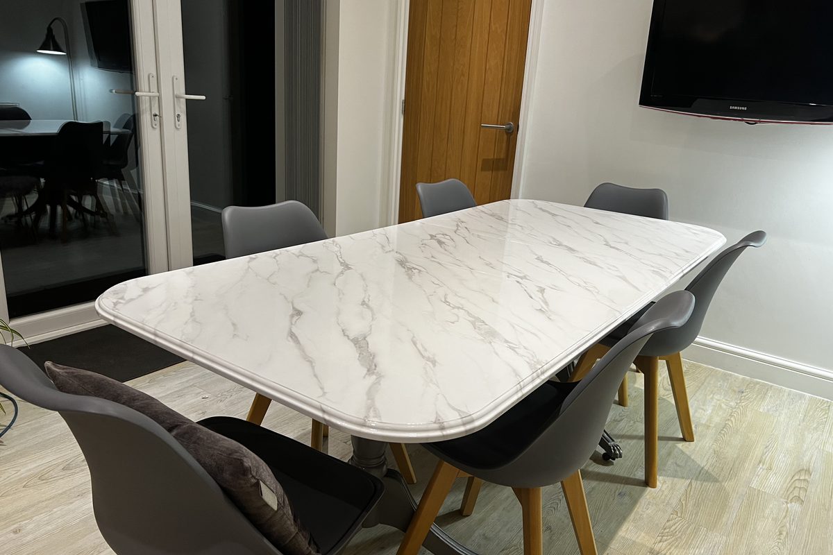 Kitchen table wrapped in a white marble effect film