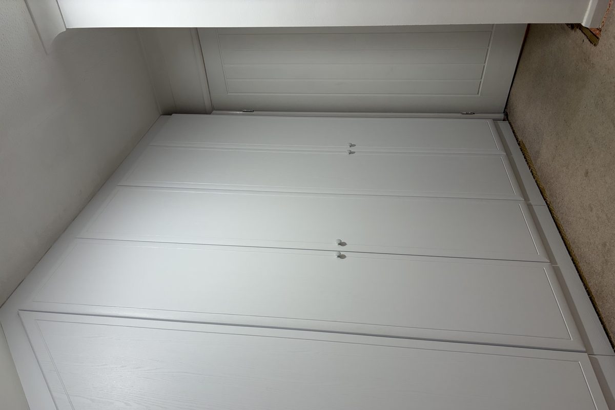 Wardrobe wrapped in white wood-effect architectural film