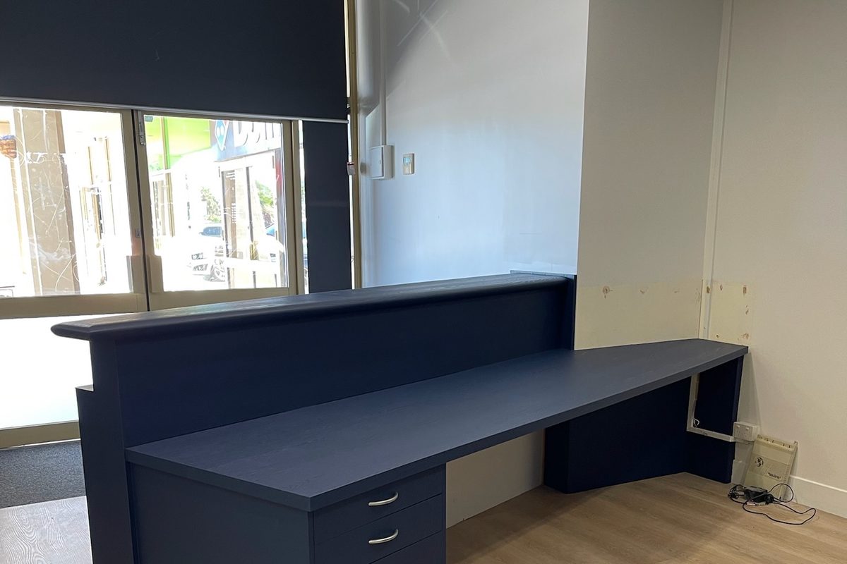 Reception desk wrapped in blue vinyl