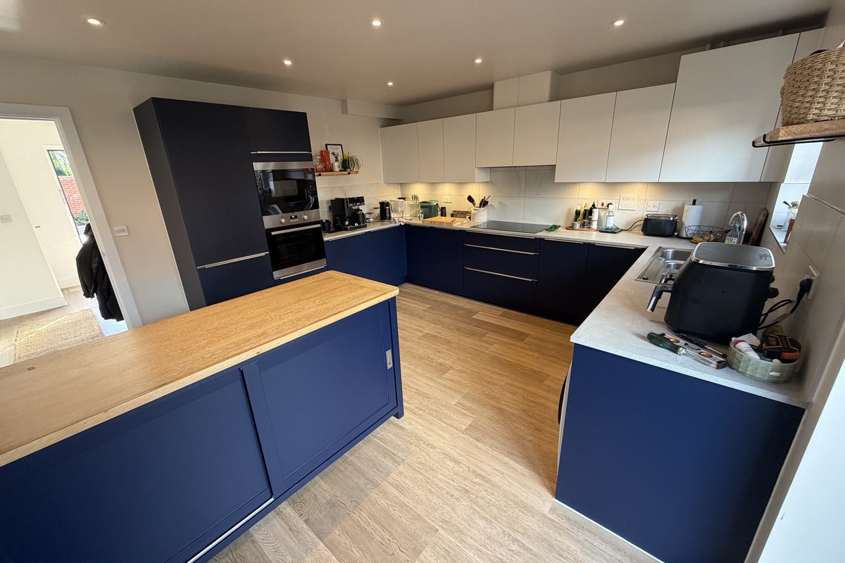 Navy matt architectural film finish specified across kitchen cabinetry